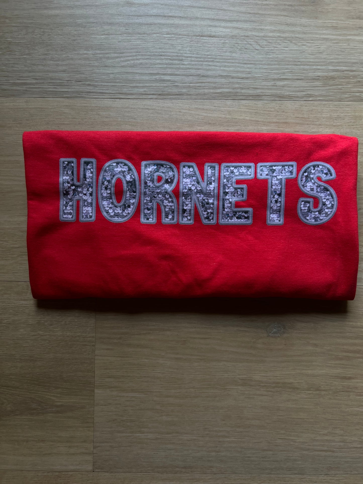 Grey Faux Sequin Hornets on red tee