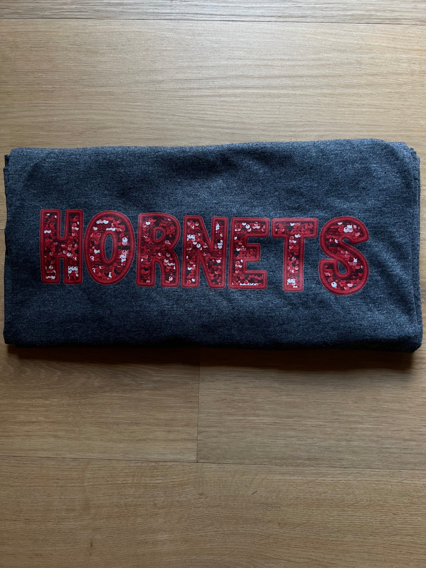 Red Faux Sequin Hornets on dark grey tee